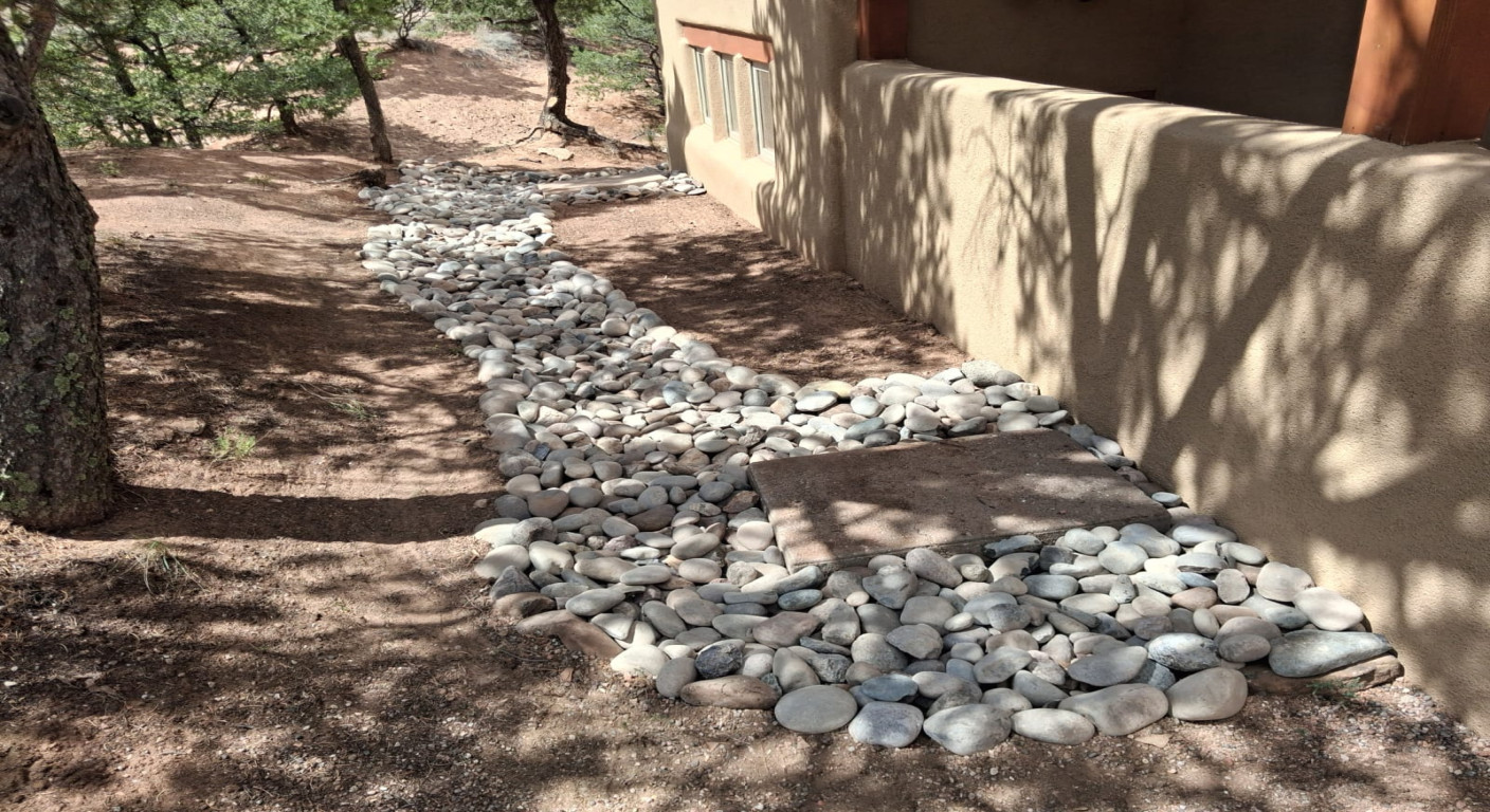 Landscape Drainage Solution: Decorative River Rock Channel