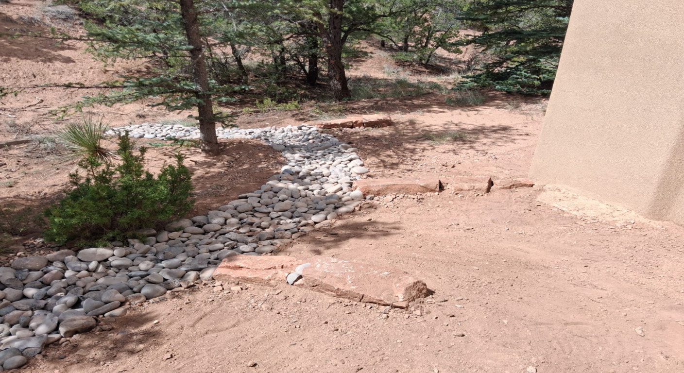 Landscape Drainage Solution: Decorative River Rock Channel